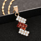 Gold-plated crystal pendant necklace close-up with red center and clear stones