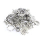 Close-up of ornate Tibetan silver crown pendants and heart/round charm medallions