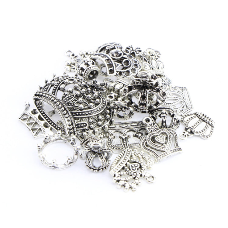 Close-up of ornate Tibetan silver crown pendants and heart/round charm medallions