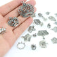 Crown pendants and charms held in an open hand, silver-toned alloy set