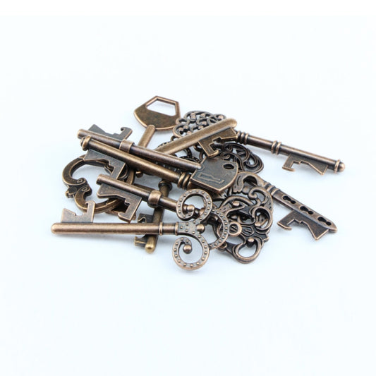 Pile of antique bronze skeleton keys with ornate cutouts and ring-like details, assorted shapes