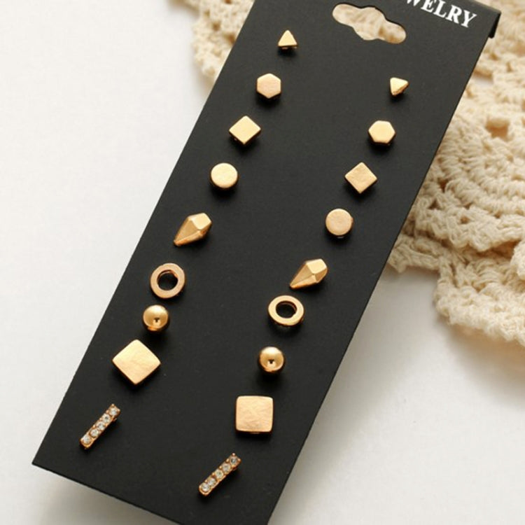 Gold-tone stud earring set with nine assorted geometric pieces on display card