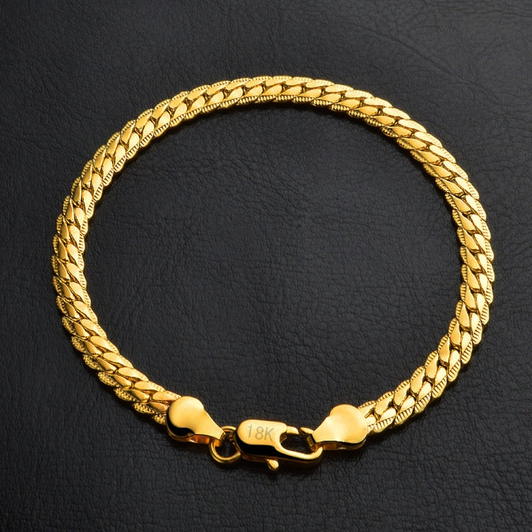 Braided yellow gold bracelet with heart clasp and stamped 18k marking at front
