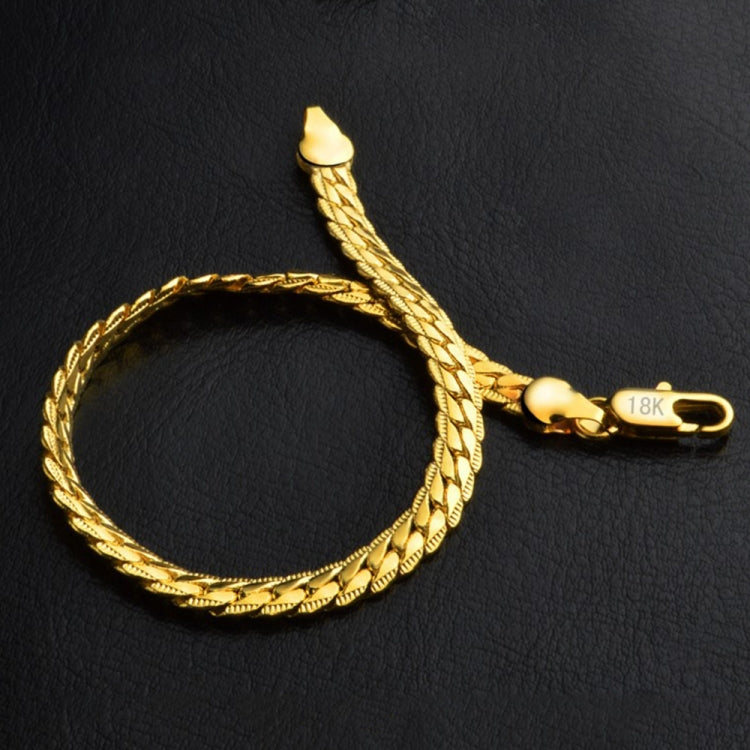 Braided yellow gold bracelet with heart clasp and raised chain links, side view