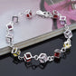 Silver rhinestone bracelet with hollow square and multicolor checker stones, close-up angle.