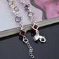 Silver bracelet with dangling multicolor hollow square rhinestone links and toggle clasp.