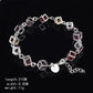 Silver rhinestone checker bracelet with heart charm and multicolor hollow square links.