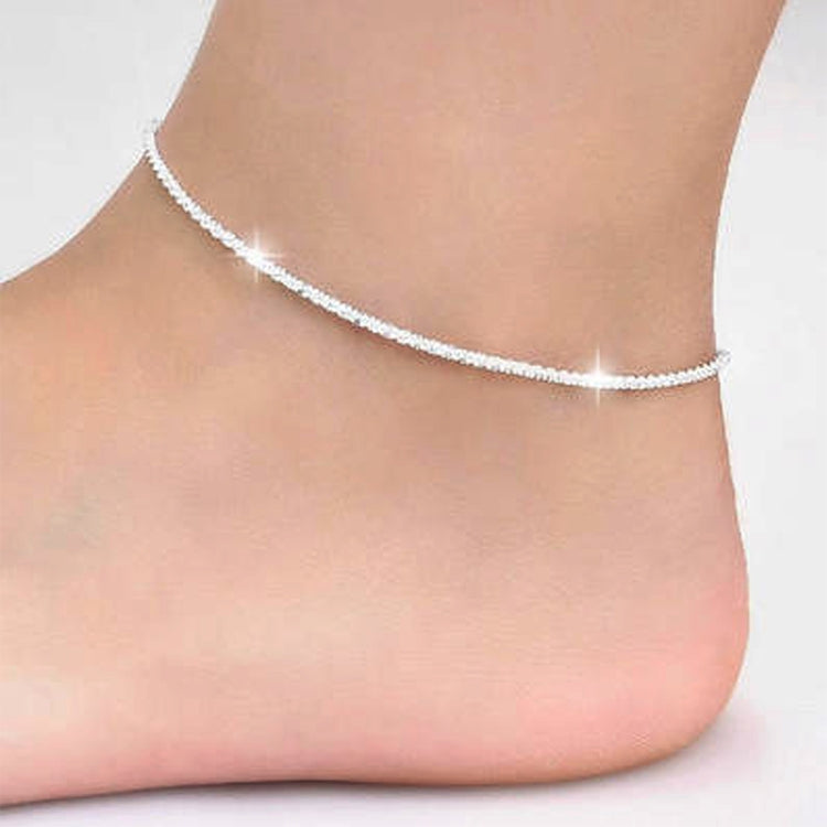 Silver plated star anklet with thin chain, worn around the ankle