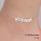 Silver-tone anklet worn on ankle with frosted bead row and small star charm