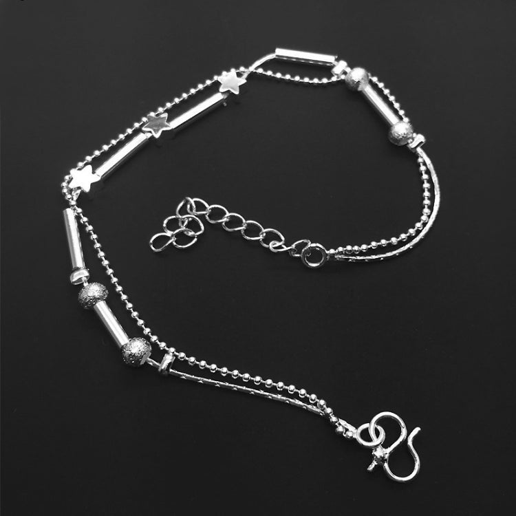 Silver-tone layered anklet with star bar charms, bead accents, and adjustable clasp