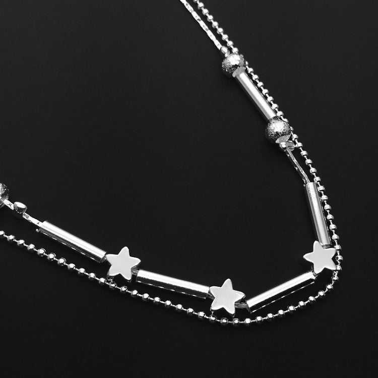 Silver-tone ankle bracelet with star charms, bead strand, and slim bar link details