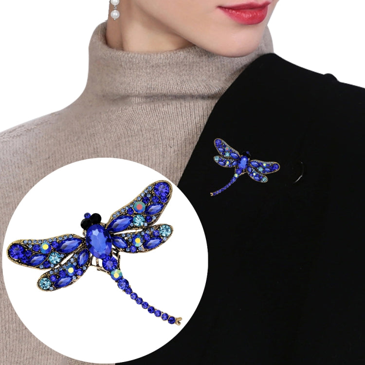Blue rhinestone dragonfly brooch with curved wings and dangling crystal tail