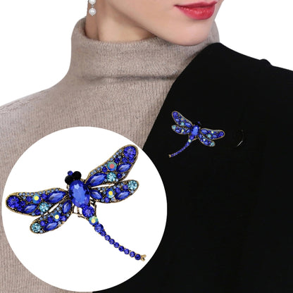 Blue rhinestone dragonfly brooch with curved wings and dangling crystal tail