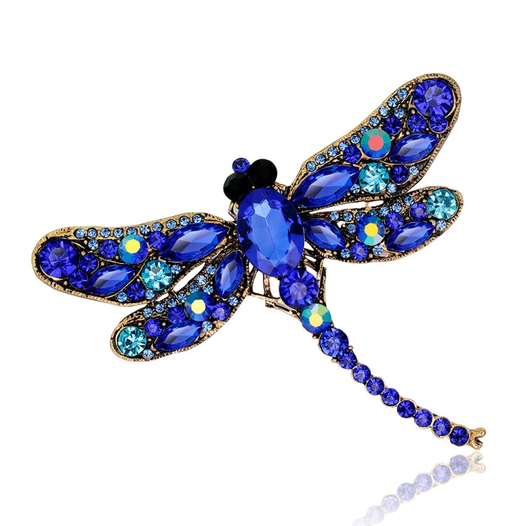 Blue rhinestone dragonfly brooch with oval gems, star accents, and long tail