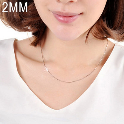 Silver 2mm snake-bone chain necklace, worn close-up on neckline