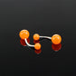 Fluorescent acrylic belly button ring with three orange glowing balls and silver bar