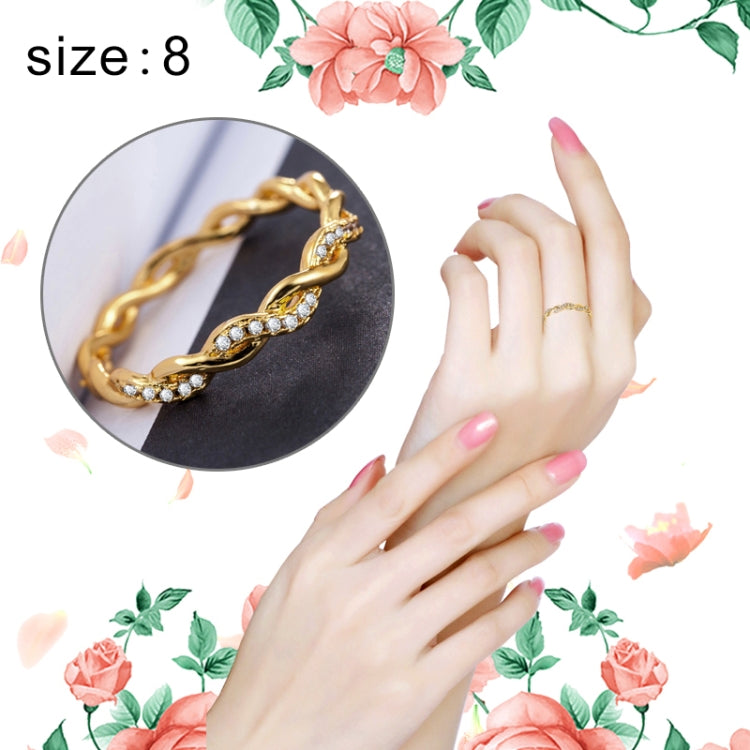 Gold twist rhinestone ring on hand, linked band design, US size 8