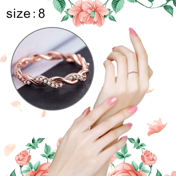 Rose gold twist rhinestone ring on hand, arched linked design, US size 8