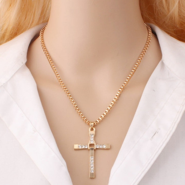 Gold rhinestone cross pendant necklace on a model's neckline