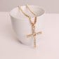Gold rhinestone cross pendant necklace on a white display bust