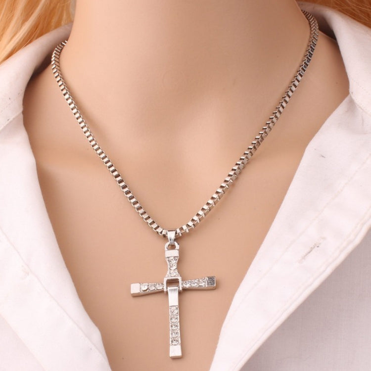 Silver rhinestone cross pendant necklace on a model's neckline