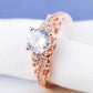 Rose gold zircon engagement ring with round center stone and pavé band