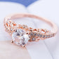 Rose gold zircon engagement ring with round clear center stone and pavé band