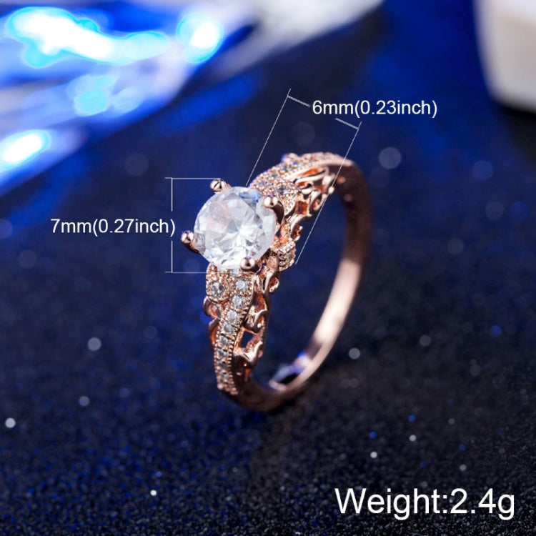 Rose gold zircon engagement ring with round clear center stone and ornate filigree band
