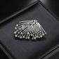 Silver rhinestone fan-shaped asymmetric stud earrings on a black jewelry box