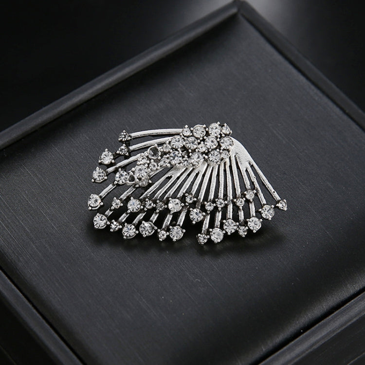 Silver rhinestone fan-shaped asymmetric stud earrings on a black jewelry box