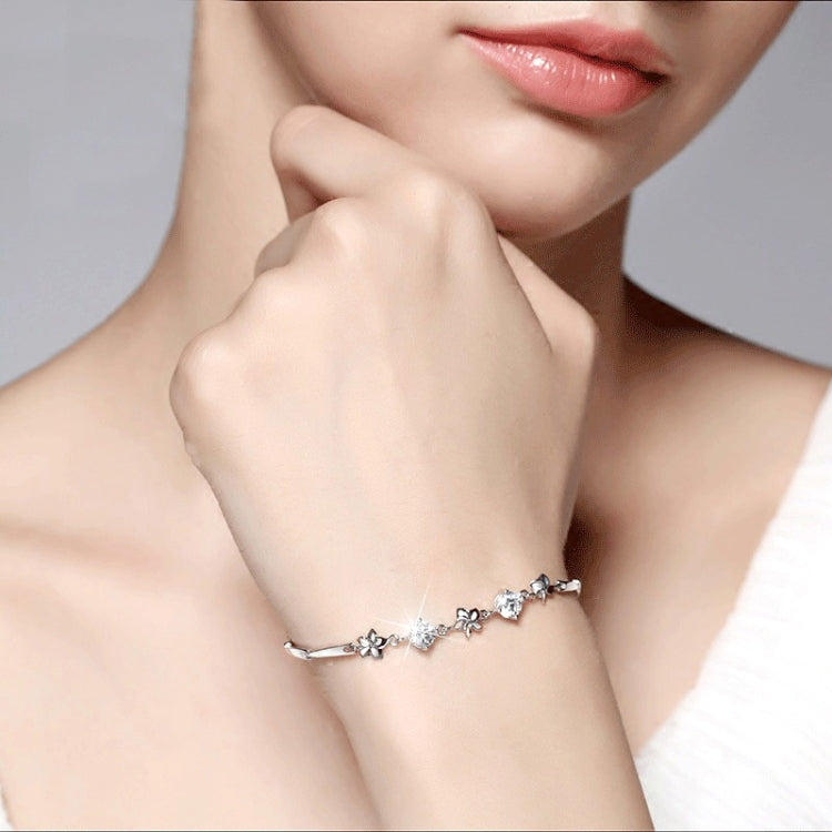 Silver-tone flower bracelet with frangipani charms and clear round stones