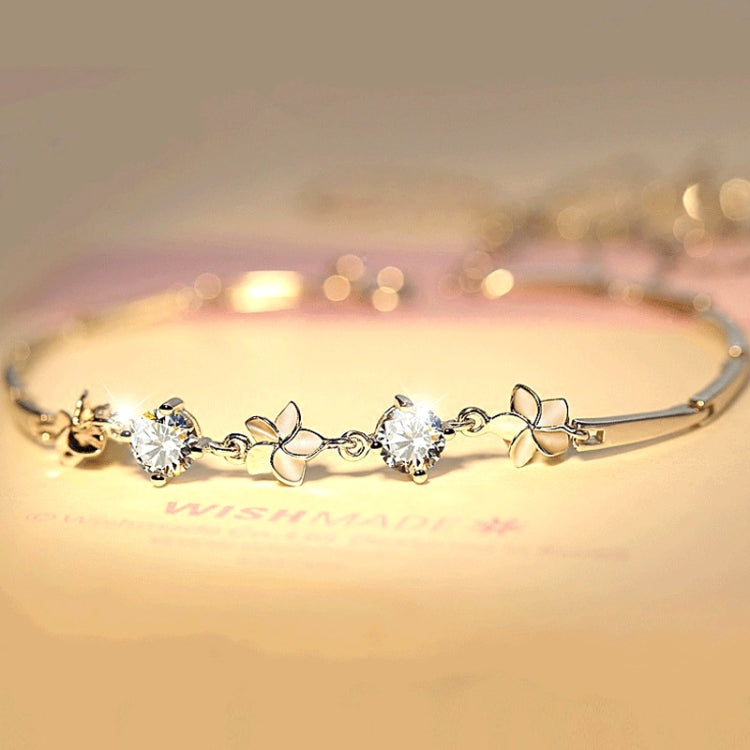 Silver-tone bracelet with round clear stones and flower-link frangipani charms