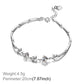 Silver-tone frangipani charm bracelet with flower accents and round clear stones