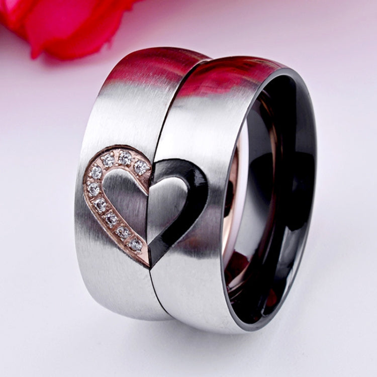 Silver-tone ring with heart cutout, black inset, and small crystal border