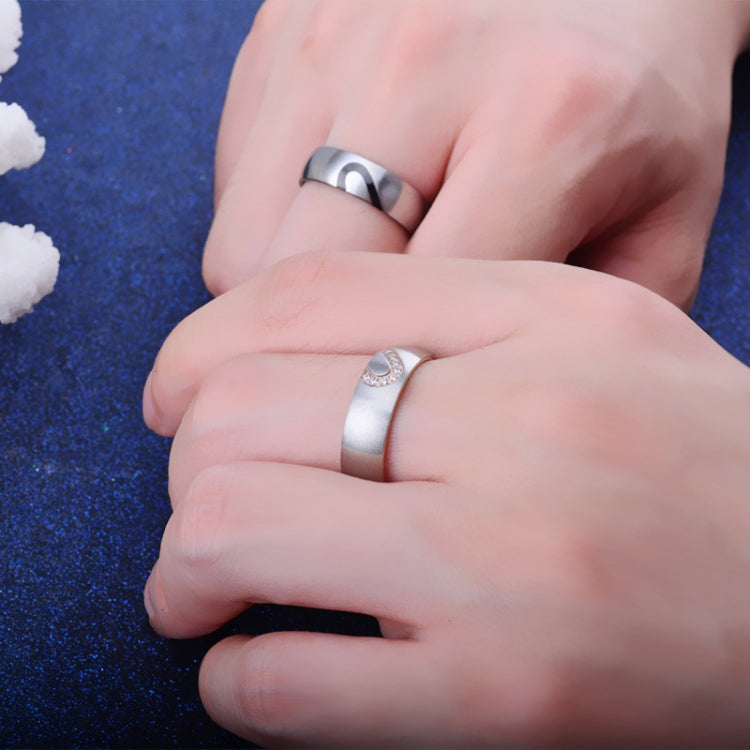Hands wearing silver rings with heart motif and small round stones