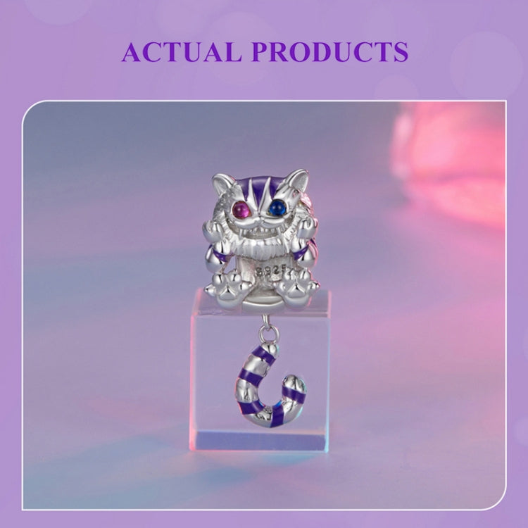 Silver cat charm pendant with purple-and-blue eyes, striped body, and dangling loop