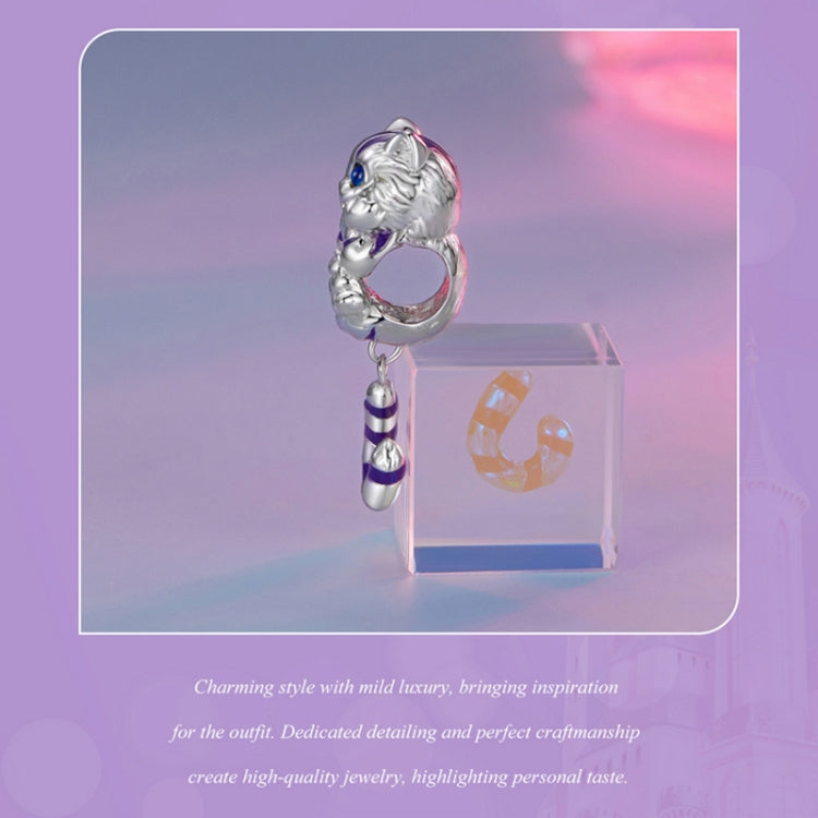 Silver cat charm pendant with purple-blue eyes and striped tail hanging from ring