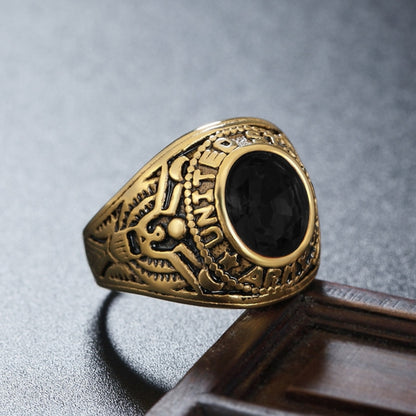 Gold-tone soldier emblem ring with black oval gemstone and carved band details