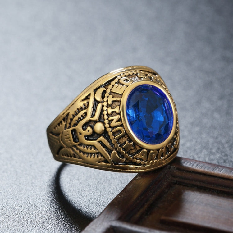 Gold-tone soldier emblem ring with blue oval gemstone and carved military-style band