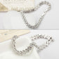 Platinum-tone zircon tennis bracelet with round stone links and visible clasp