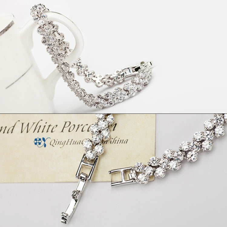 Zircon tennis bracelet with faceted links, box clasp, and safety hinge