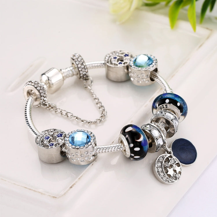 Beaded charm bracelet with blue stones and circular charms, silver-tone chain bracelet