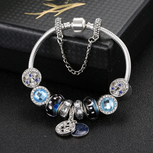 Silver beaded charm bracelet with blue star-moon beads and oval pendants