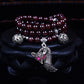 Dark maroon beaded bracelet with silver cat-like charm and round bead spacers