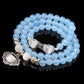 Light blue beaded bracelet with heart charm and small elephant figurine charm
