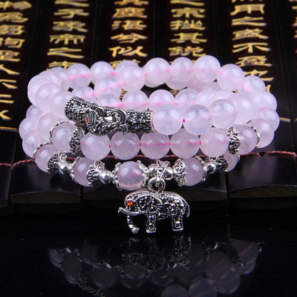 Pink beaded bracelet with silver elephant charm and crystal-like spacer beads