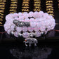 Pink beaded bracelet with stacked strands, silver elephant charm, and bead spacers