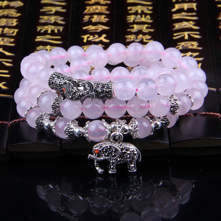 Pink beaded bracelet with stacked strands, silver elephant charm, and bead spacers