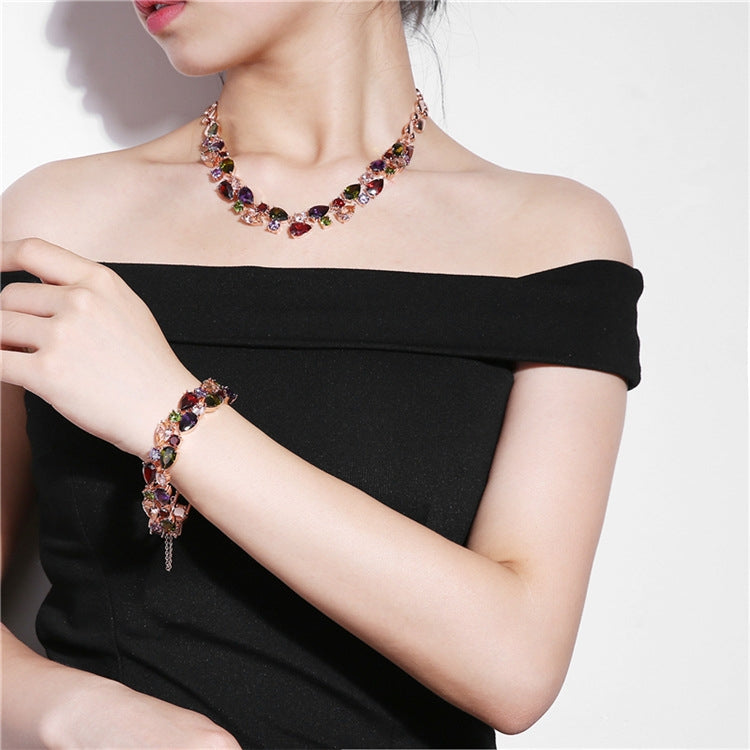 Rose gold tone multicolor zircon bead bracelet and matching necklace on off-shoulder black dress