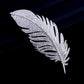Silver-tone feather brooch with layered crystal sparkle